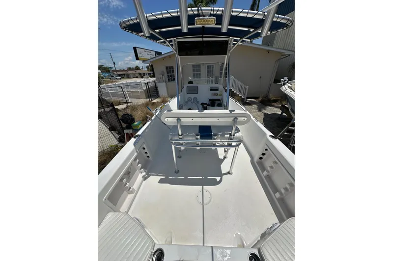 Slide: The Image of 2008 Pro-Line 20 Sport boat interior with seating and console, docked outdoors. - 12