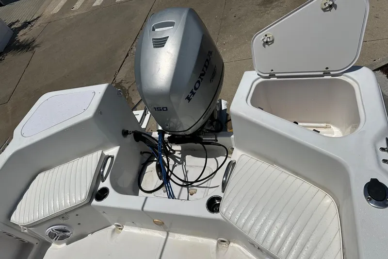 Slide: The Image of 2008 Pro-Line 20 Sport boat with Honda 150 outboard motor, open storage compartments. - 13