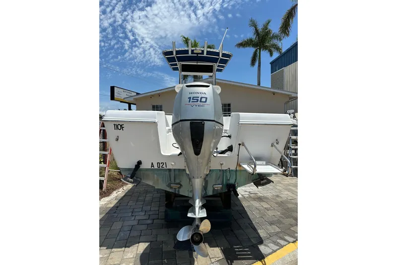 Slide: The Image of 2008 Pro-Line 20 Sport boat with Honda 150 VTEC engine, docked under a sunny sky. - 4