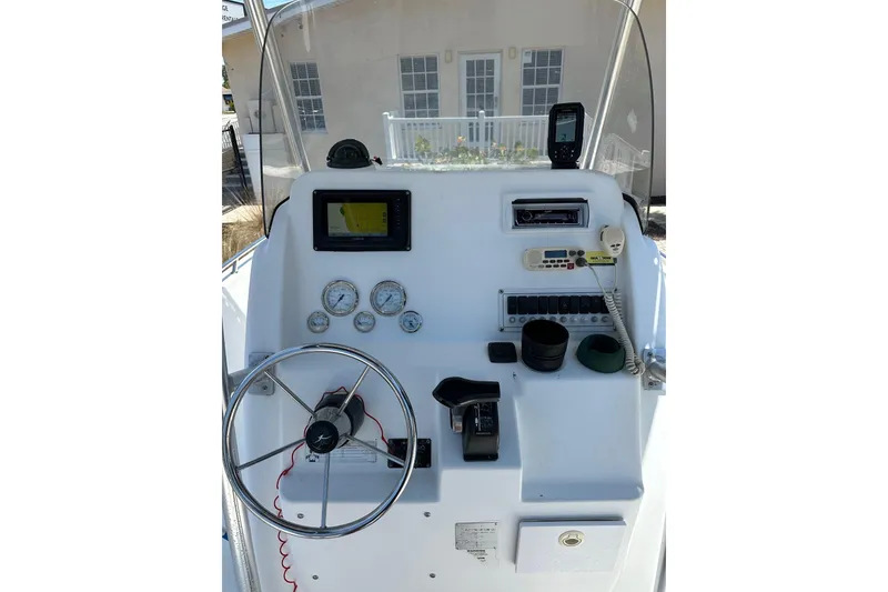 Slide: The Image of 2008 Pro-Line 20 Sport boat dashboard with steering wheel, gauges, and navigation equipment. - 7