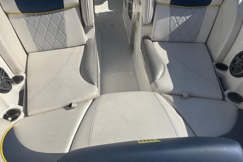Slide: The Image of 2015 MasterCraft X23 boat interior with gray seating and cup holders. - 4