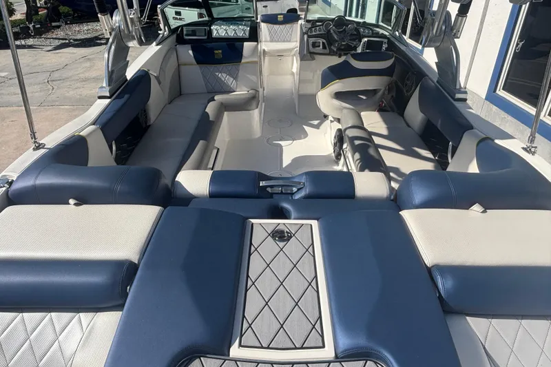 Slide: The Image of 2015 MasterCraft X23 boat interior with blue and white seating, showcasing luxury design. - 5