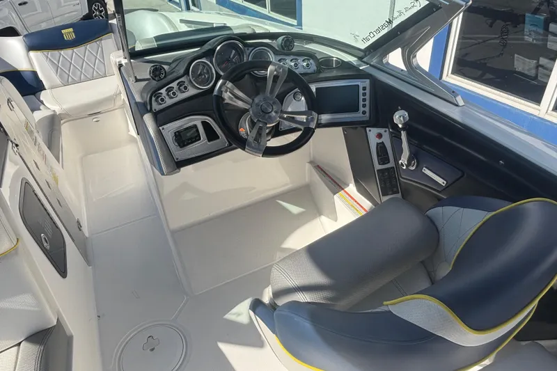 Slide: The Image of 2015 MasterCraft X23 boat interior with steering wheel and dashboard controls. - 6