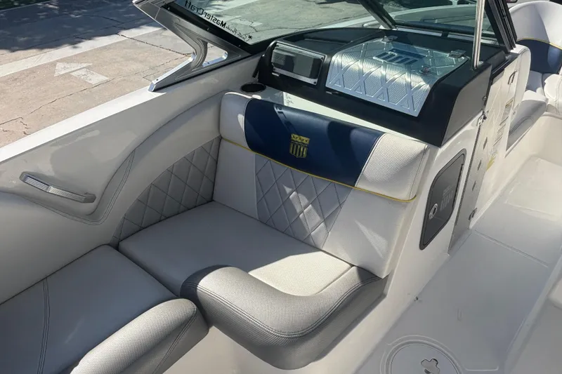 Slide: The Image of Interior of 2015 MasterCraft X23 boat with luxurious seating and dashboard. - 7