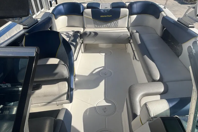 Slide: The Image of 2015 MasterCraft X23 boat interior with spacious seating and modern design. - 8