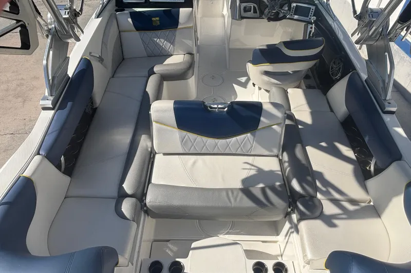 Slide: The Image of 2015 MasterCraft X23 boat interior with luxurious seating and modern dashboard. - 9