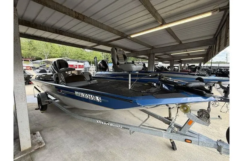 The Image of 2008 Triton TS-18 boat on trailer under shelter, blue color, side view. - 0