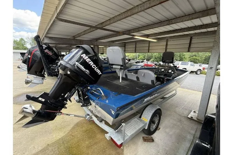 Slide: The Image of 2008 Triton TS-18 boat with Mercury outboard motor on a trailer under a shelter. - 3