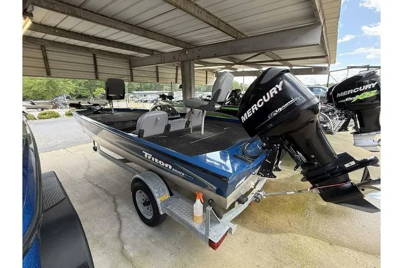 Slide: The Image of 2008 Triton TS-18 boat with Mercury outboard motor on a trailer under a metal canopy. - 5