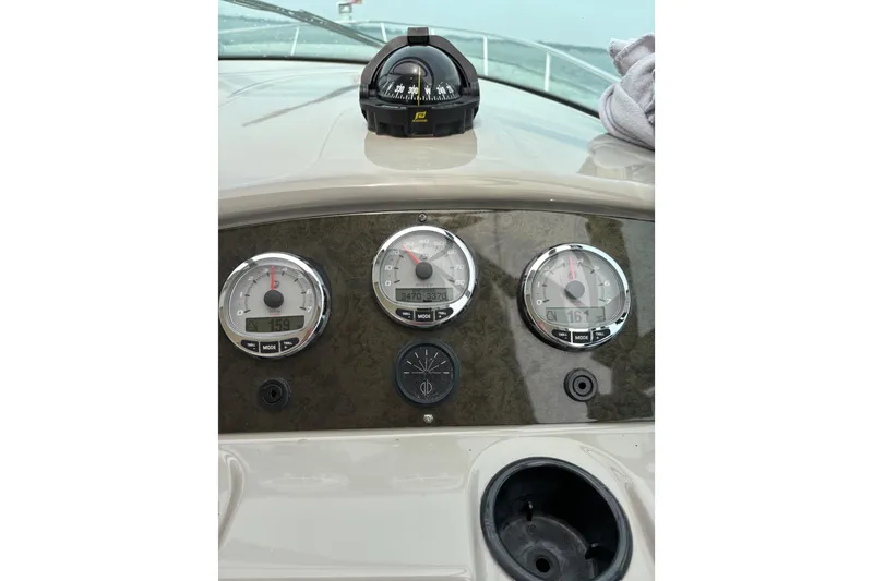 Slide: The Image of Dashboard of a 2003 Cruisers Yachts 3470 Express with gauges and compass. - 13
