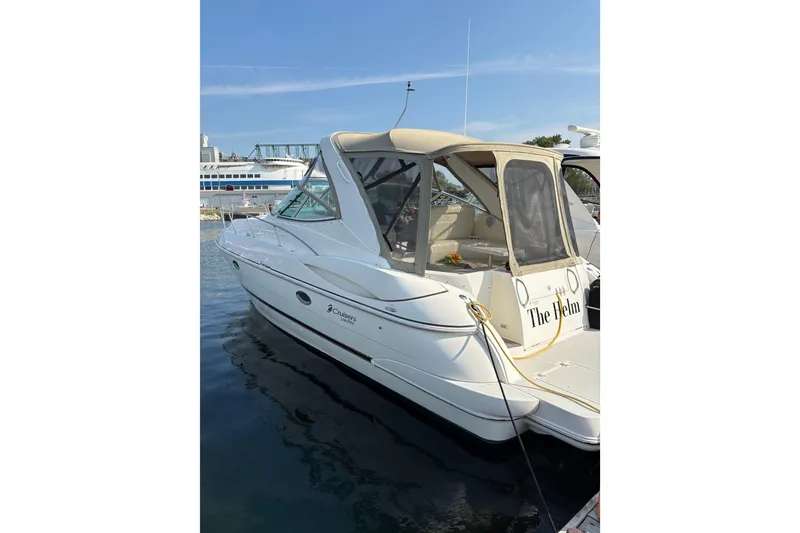 Slide: The Image of 2003 Cruisers Yachts 3470 Express docked, featuring sleek design and beige canopy. - 2
