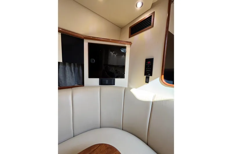 Slide: The Image of Interior of 2003 Cruisers Yachts 3470 Express with beige seating and control panel. - 21
