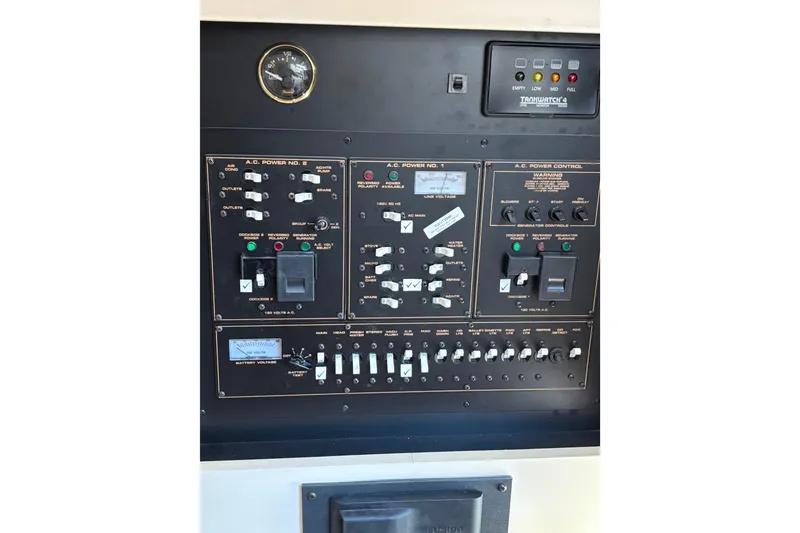 Slide: The Image of Control panel of a 2003 Cruisers Yachts 3470 Express, featuring various switches and gauges. - 26