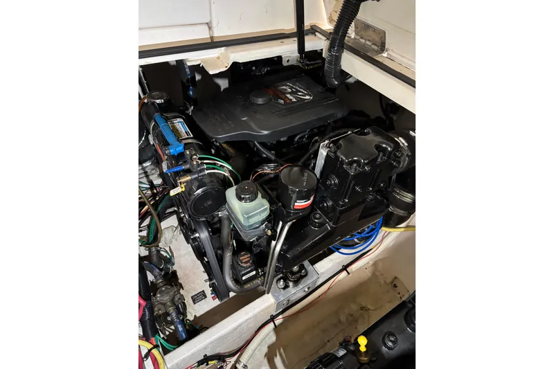 Slide: The Image of Engine compartment of a 2003 Cruisers Yachts 3470 Express, showcasing detailed mechanical components. - 28