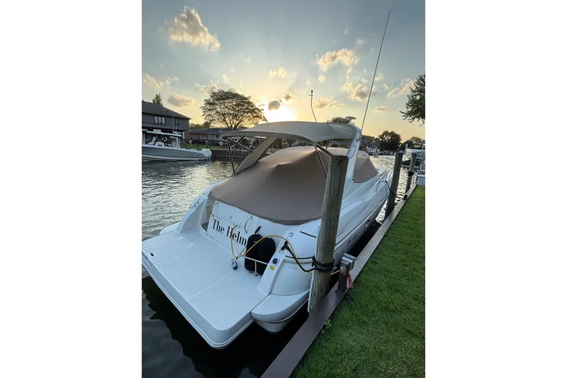 Slide: The Image of 2003 Cruisers Yachts 3470 Express docked at sunset, covered and secured. - 3