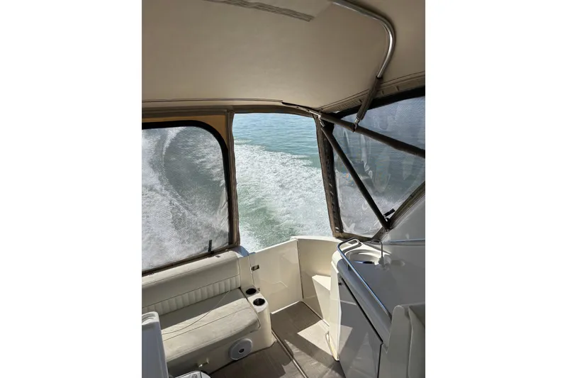 Slide: The Image of Interior view of 2003 Cruisers Yachts 3470 Express, showcasing seating and water wake. - 5