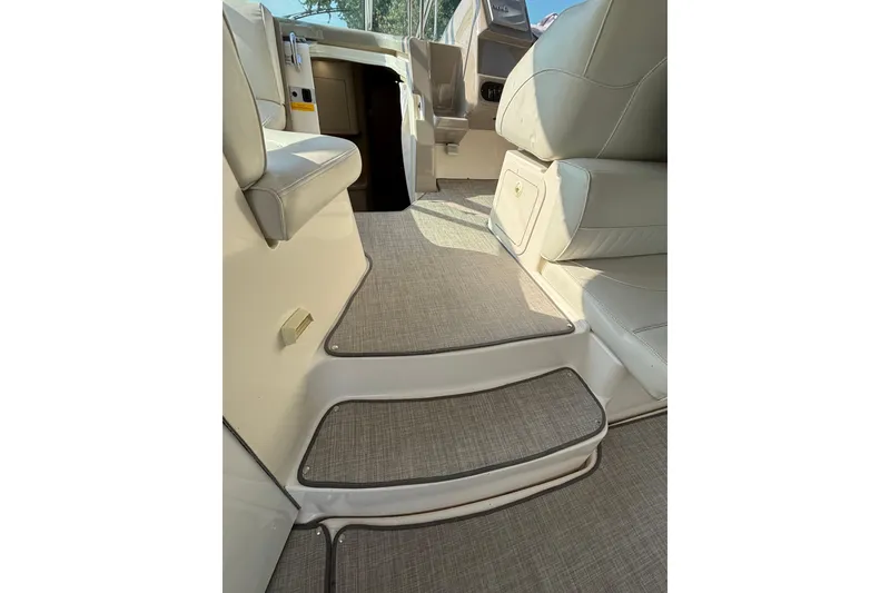 Slide: The Image of Interior view of 2003 Cruisers Yachts 3470 Express, featuring elegant seating and carpeted steps. - 7