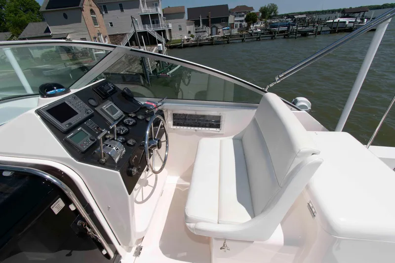 Slide: The Image of 1995 Bertram 30 Moppie boat cockpit with steering wheel and navigation instruments. - 10
