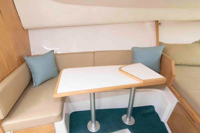 Slide: The Image of Interior of a 1995 Bertram 30 Moppie boat with a cozy seating area and table. - 17
