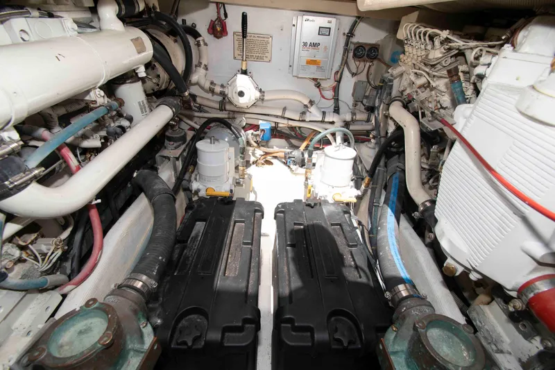 Slide: The Image of Engine room of a 1995 Bertram 30 Moppie boat, showcasing mechanical components and wiring. - 19
