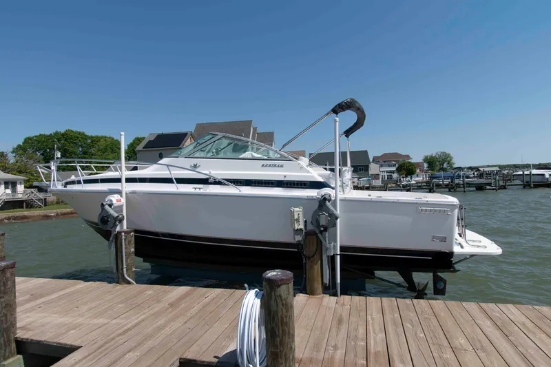 Slide: The Image of 1995 Bertram 30 Moppie boat docked at a marina under clear blue skies. - 2