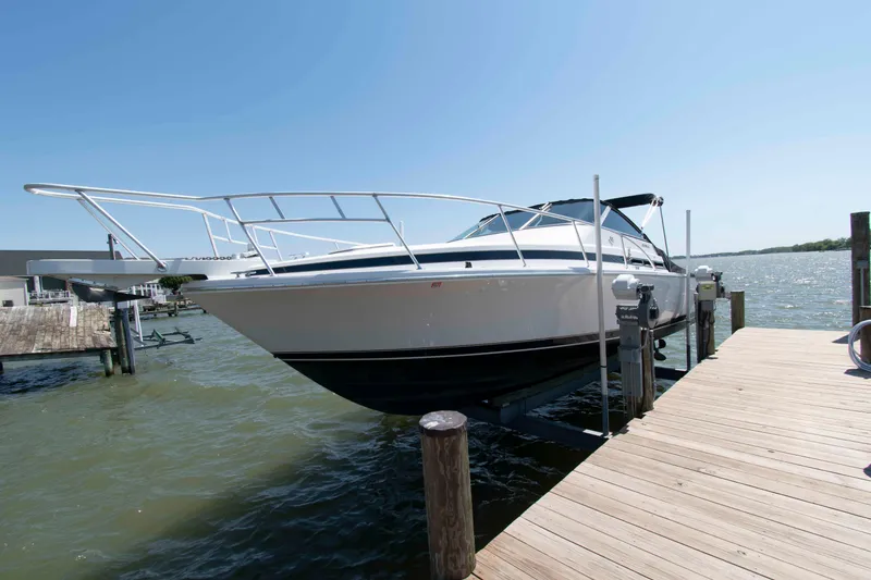 Slide: The Image of 1995 Bertram 30 Moppie boat docked on a sunny day by the water. - 3