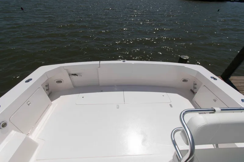 Slide: The Image of Spacious deck of a 1995 Bertram 30 Moppie boat overlooking calm waters. - 6
