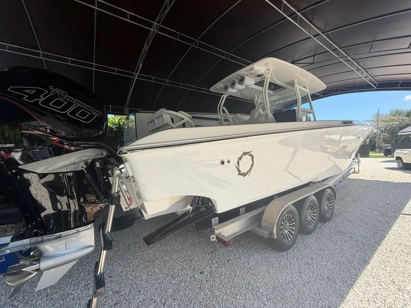 Slide: The Image of 2007 Fountain 38 Center Console boat on trailer under cover. - 2