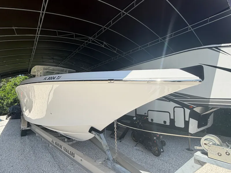 Slide: The Image of 2007 Fountain 38 Center Console boat on trailer under cover. - 3
