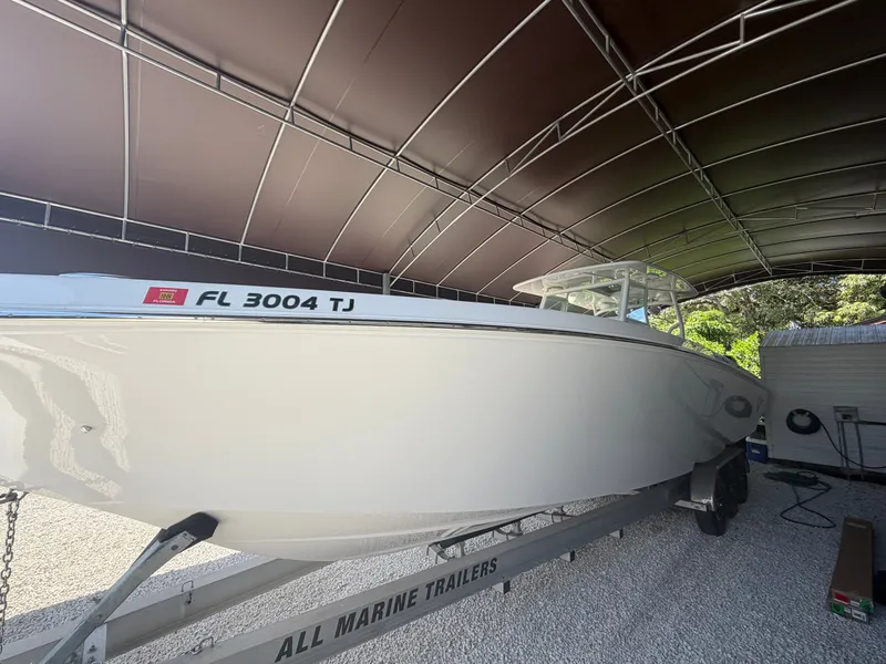 Slide: The Image of 2007 Fountain 38 Center Console boat on trailer under cover. - 4