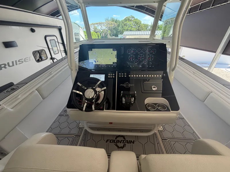 Slide: The Image of 2007 Fountain 38 Center Console helm with modern electronics. - 6