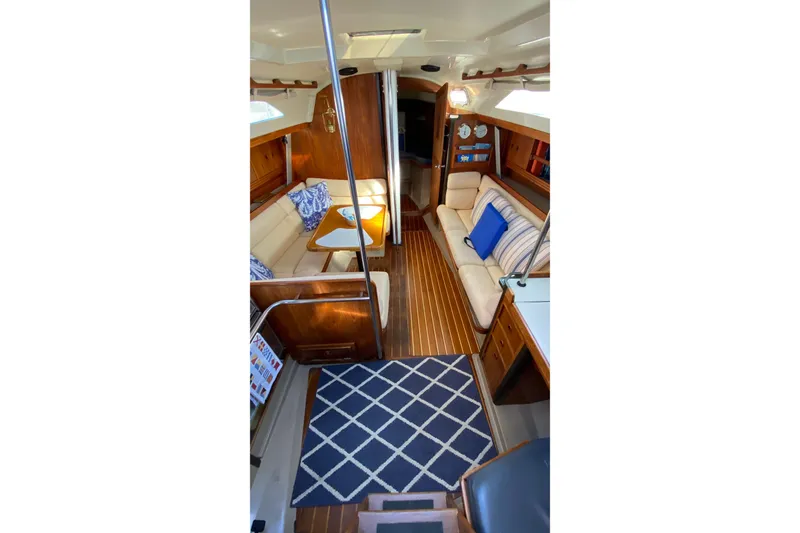 Slide: The Image of Interior of 1987 C&C Mark III sailboat with cozy seating and nautical decor. - 10