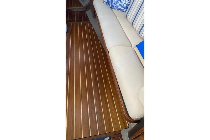 Slide: The Image of 1987 C&C Mark III interior with wooden flooring and beige seating. - 12
