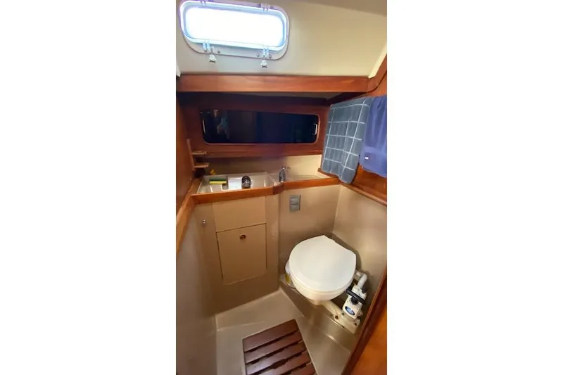 Slide: The Image of 1987 C&C Mark III yacht bathroom with wooden accents and compact design. - 14