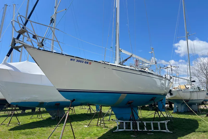 Slide: The Image of 1987 C&C Mark III sailboat on stands, ready for maintenance under a clear blue sky. - 17