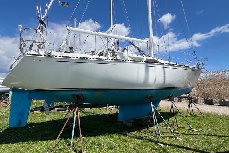 Slide: The Image of 1987 C&C Mark III sailboat on stands, displayed outdoors under a clear blue sky. - 20