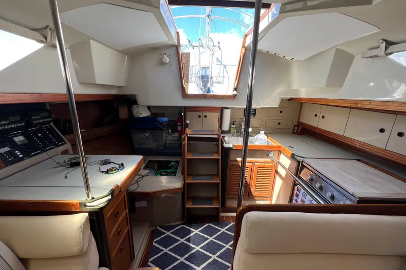 Slide: The Image of Interior of 1987 C&C Mark III sailboat with kitchen and navigation area. - 47