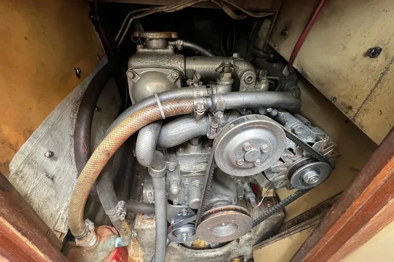 Slide: The Image of 1987 C&C Mark III engine compartment with visible belts and hoses. - 54