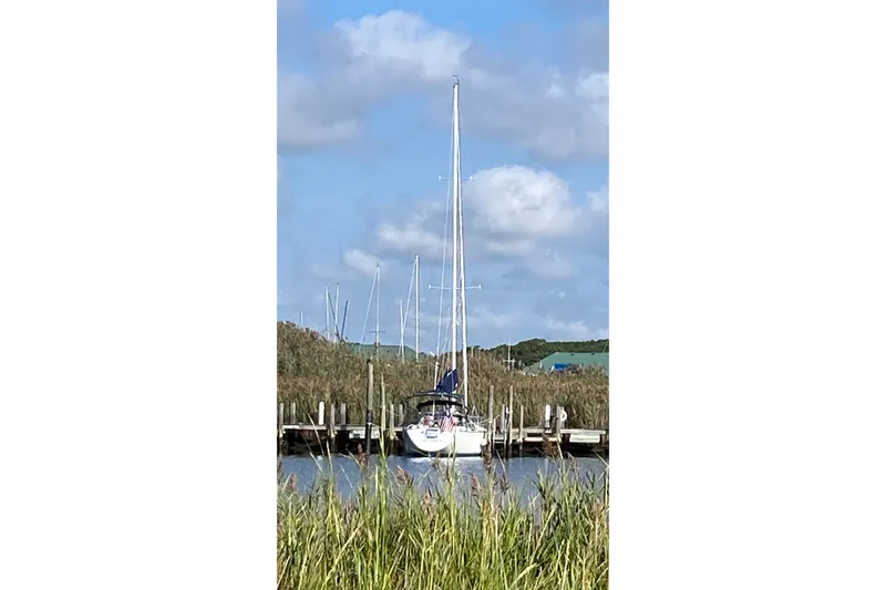 Slide: The Image of Sailboat docked in a serene marina, C&C Mark III, 1987 model. - 7