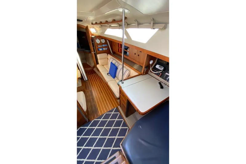 Slide: The Image of Interior of 1987 C&C Mark III sailboat with cozy seating and navigation area. - 9