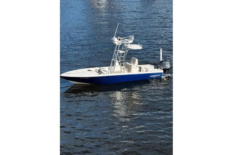 Slide: The Image of 2018 Pathfinder 2500 Hybrid boat on calm water, featuring a sleek blue and white design. - 13