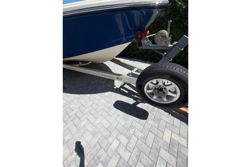 Slide: The Image of 2018 Pathfinder 2500 Hybrid boat on trailer, parked on paved surface. - 15