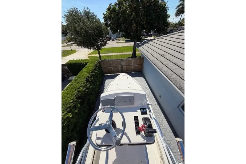 Slide: The Image of 2018 Pathfinder 2500 Hybrid boat parked in driveway, top view. - 16
