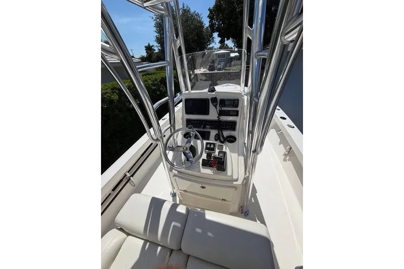 Slide: The Image of 2018 Pathfinder 2500 Hybrid boat console with steering wheel and navigation controls. - 18