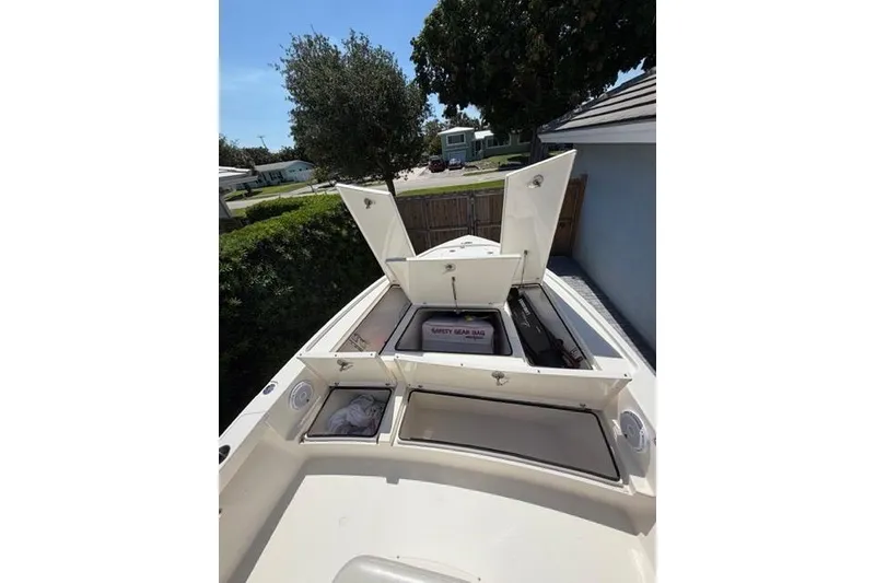 Slide: The Image of 2018 Pathfinder 2500 Hybrid boat with open storage compartments and safety gear bag. - 19