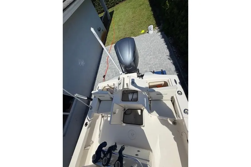 Slide: The Image of 2018 Pathfinder 2500 Hybrid boat with outboard motor, parked on driveway. - 4