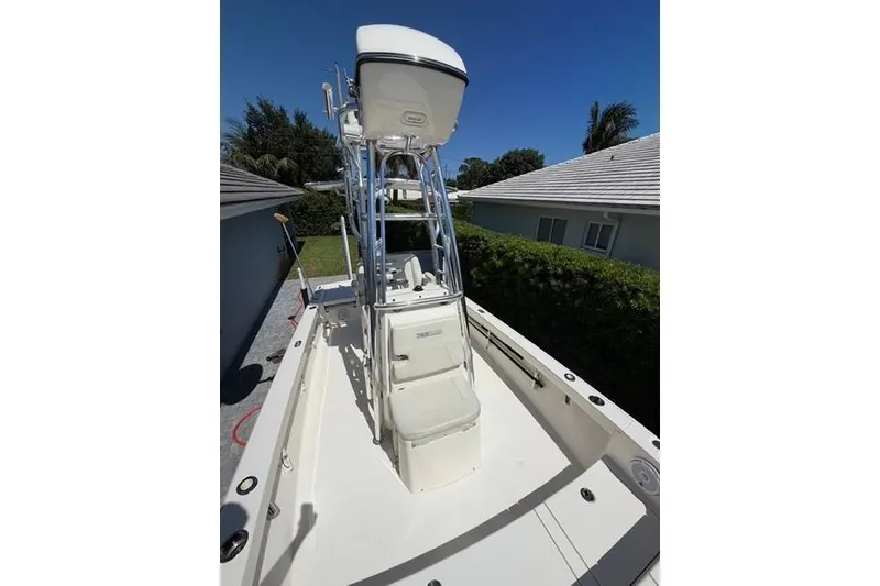 Slide: The Image of 2018 Pathfinder 2500 Hybrid boat with elevated helm station, parked outdoors. - 7