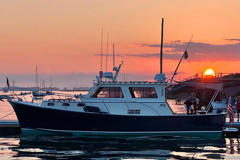 The Image of Eastern 35 Casco Bay boat at sunset, 2017 model, docked in serene waters. - 1