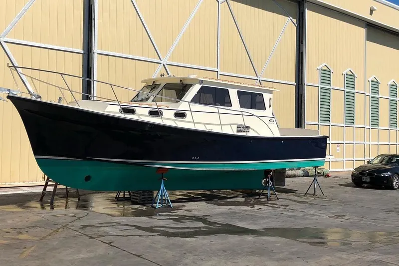 Slide: The Image of 2017 Eastern 35 Casco Bay boat on stands outside a large warehouse. - 3