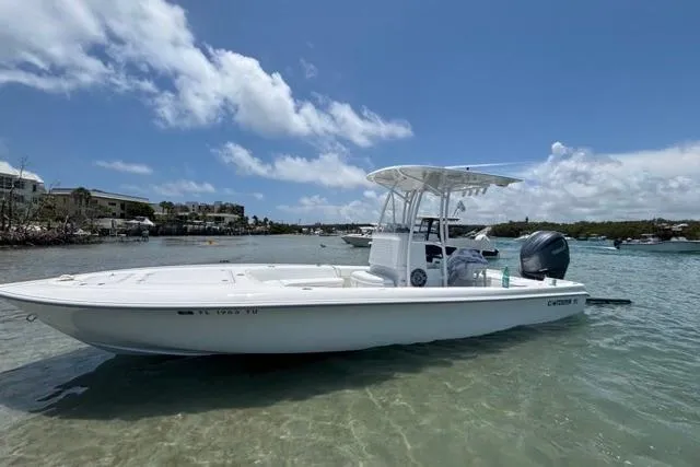 The Image of 2022 Contender 25 Bay boat on clear water under a blue sky. - 0